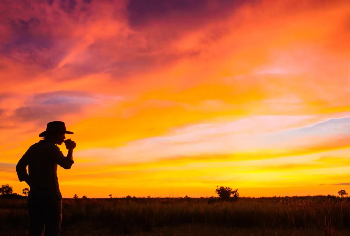 Woman-drinking-coffee-while-watching-the-sunrise-in-Botswana_7377d849afdaaf98a9d8db3bf5dd57e9