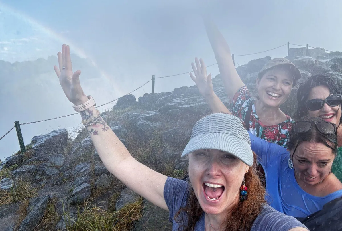 four-women-getting-soaked-in-the-spray-of-victoria-falls_7377d849afdaaf98a9d8db3bf5dd57e9