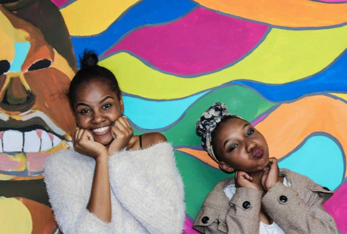 two-girls-posing-in-front-of-a-wall-mural-in-harare-zimbabwe-on-international-womens-day_7377d849afdaaf98a9d8db3bf5dd57e9